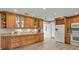 A kitchen featuring custom wood cabinets, granite countertops, and modern appliances at 12603 Corral Rd, Tampa, FL 33626