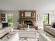 Cozy living room with brick fireplace, stylish furniture, and large windows offering natural light at 12603 Corral Rd, Tampa, FL 33626