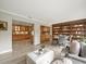 Open concept living room with hardwood floors, shelves, and seamless flow to the kitchen at 12603 Corral Rd, Tampa, FL 33626