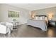 Spacious main bedroom features an accent wall, dark hardwood floors, and natural light at 12603 Corral Rd, Tampa, FL 33626