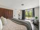 Cozy main bedroom featuring wood floors, a balcony, and ample closet space at 12603 Corral Rd, Tampa, FL 33626