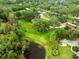 Large parcel featuring sprawling lawn, mature trees, and a serene pond at 12603 Corral Rd, Tampa, FL 33626