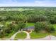Aerial image defining property lines of land surrounded by mature trees and a pond at 12603 Corral Rd, Tampa, FL 33626