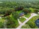 Aerial view showcasing mature trees and pond, within a defined parcel at 12603 Corral Rd, Tampa, FL 33626