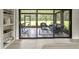 Relaxing sun room with wicker furniture and sliding glass doors leading to the outdoor space at 12603 Corral Rd, Tampa, FL 33626