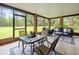 Relaxing sunroom with tile flooring, comfortable seating and dining set at 12603 Corral Rd, Tampa, FL 33626