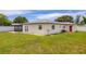 View of the home's backyard, showcasing the lawn, fence, and exterior at 12877 Palm Dr, Largo, FL 33774