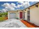 Close up view of a well-maintained one story home and manicured landscaping at 12877 Palm Dr, Largo, FL 33774