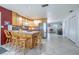 Spacious open kitchen featuring a central island with seating, ample counter space, and stainless steel appliances at 12877 Palm Dr, Largo, FL 33774