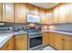 Close-up of the kitchen showcasing stainless steel range, microwave, and ample cabinetry at 12877 Palm Dr, Largo, FL 33774