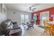 Inviting living room featuring tile floors, comfortable seating, and backyard views at 12877 Palm Dr, Largo, FL 33774