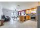 Open-concept living space blending kitchen, dining, and living areas with tile floors at 12877 Palm Dr, Largo, FL 33774