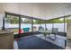 Enclosed sunroom with tile flooring and views of the fenced backyard at 12877 Palm Dr, Largo, FL 33774
