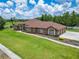 Beautiful home with lush landscaping and manicured grounds at 13102 Done Groven Dr, Dover, FL 33527