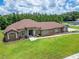 A sprawling house with a well-manicured lawn and lush landscaping at 13102 Done Groven Dr, Dover, FL 33527