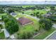 Single-story home with large lawn and manicured garden beds in quiet neighborhood with mature trees at 13102 Done Groven Dr, Dover, FL 33527