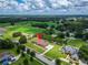 Charming single-story home with a lush green lawn, complemented by mature trees in a countryside locale at 13102 Done Groven Dr, Dover, FL 33527