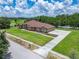 Stunning aerial view of the home showcasing its expansive driveway and well-maintained landscaping at 13102 Done Groven Dr, Dover, FL 33527