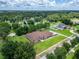 Spacious single-story home with a well-manicured lawn and mature trees in a serene, wooded neighborhood setting at 13102 Done Groven Dr, Dover, FL 33527
