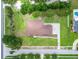 Aerial view of home with a well-maintained lawn, mature trees, and landscaping at 13102 Done Groven Dr, Dover, FL 33527