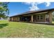 Home exterior featuring a covered patio at 13102 Done Groven Dr, Dover, FL 33527