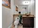 Well-lit powder room featuring unique vessel sink, granite countertop, and decorative lighting at 13102 Done Groven Dr, Dover, FL 33527