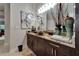 Bathroom features a vessel sink atop a granite countertop and dark wood cabinetry at 13102 Done Groven Dr, Dover, FL 33527