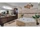 Stylish bathroom with a jacuzzi tub, dark wood cabinets, and modern fixtures at 13102 Done Groven Dr, Dover, FL 33527