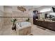 Elegant bathroom featuring a soaking tub, dual vanities, and tasteful decor at 13102 Done Groven Dr, Dover, FL 33527