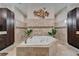 Large bathroom with dual dark-wood cabinets and jacuzzi tub between cabinets at 13102 Done Groven Dr, Dover, FL 33527