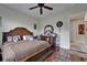 Spacious bedroom features a large bed, ceiling fan, and gleaming hardwood floors at 13102 Done Groven Dr, Dover, FL 33527