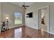Bedroom with wood floors, ceiling fan, and large window for natural light at 13102 Done Groven Dr, Dover, FL 33527