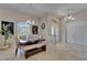 Well-lit dining room featuring a unique table setting, stylish lighting, and chic decor at 13102 Done Groven Dr, Dover, FL 33527