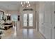 Elegant foyer featuring tiled floors, chandelier, and a view into the dining area at 13102 Done Groven Dr, Dover, FL 33527
