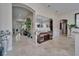 Inviting foyer featuring elegant tile flooring, an arched doorway, and stylish decorations at 13102 Done Groven Dr, Dover, FL 33527