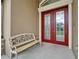 Elegant double front doors with decorative glass panels, paired with a cozy bench on the porch at 13102 Done Groven Dr, Dover, FL 33527