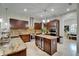 Stylish kitchen with custom island, granite countertops, stainless steel appliances, and tiled backsplash at 13102 Done Groven Dr, Dover, FL 33527