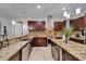 Spacious kitchen with granite counters, stainless appliances, a center island with seating, and wine storage at 13102 Done Groven Dr, Dover, FL 33527