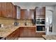 A gourmet kitchen showcasing dark wood cabinets, granite countertops, and stainless double oven at 13102 Done Groven Dr, Dover, FL 33527