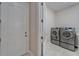 Clean laundry room boasting modern washer and dryer set for convenient laundry access at 13102 Done Groven Dr, Dover, FL 33527
