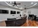 Entertainment area with a reclining sofa, multiple screens, recessed lighting, and a wet bar at 13102 Done Groven Dr, Dover, FL 33527