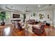 Comfortable living room with hardwood floors, a fireplace, and a large TV at 13102 Done Groven Dr, Dover, FL 33527