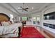 Bright main bedroom suite with hardwood floors, ceiling fans, sitting area, and private access to screened patio at 13102 Done Groven Dr, Dover, FL 33527