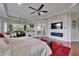 Large main bedroom suite with ceiling fans, hardwood floors, red rug and private access to the screened in patio at 13102 Done Groven Dr, Dover, FL 33527
