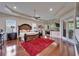 Spacious main bedroom with a large bed, hardwood floors, red rug, recessed lighting, and two ceiling fans at 13102 Done Groven Dr, Dover, FL 33527