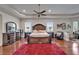 Hardwood floors, a king-size bed, dark furnishings, and natural light define this spacious main bedroom at 13102 Done Groven Dr, Dover, FL 33527