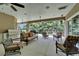 Covered outdoor patio, ideal for relaxation, complete with ceiling fans and grilling area at 13102 Done Groven Dr, Dover, FL 33527