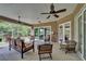 Inviting covered patio with seating area, ceiling fans, and serene views at 13102 Done Groven Dr, Dover, FL 33527