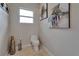 Well-lit powder room features tiled floors and modern artistic accents at 13102 Done Groven Dr, Dover, FL 33527