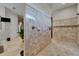 Walk-in shower boasting neutral tile and a seamless glass enclosure at 13102 Done Groven Dr, Dover, FL 33527